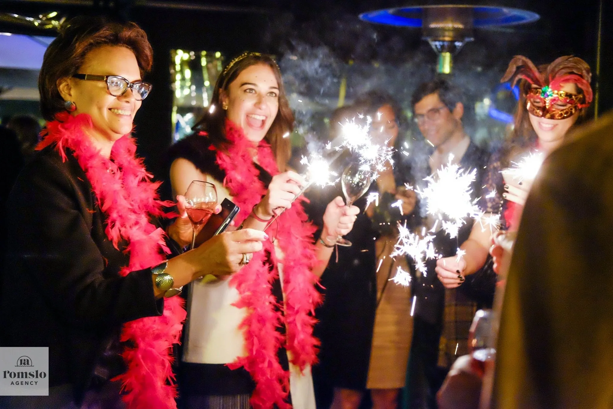 Group of people celebrating New Year's Eve with sparklers