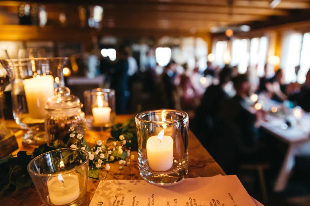 Beautiful candles elegantly arranged in a restaurant for a memorial event.