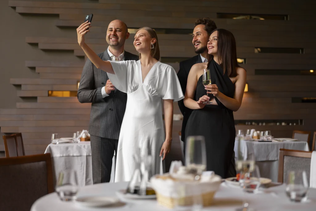 Bride and groom posing for a picture with friends at their wedding, everyone smiling and celebrating together.