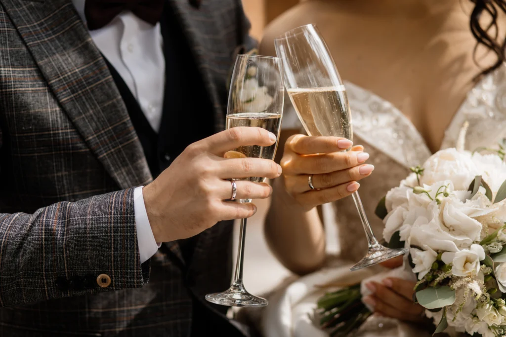 Bride and groom toasting with champagne at their wedding.