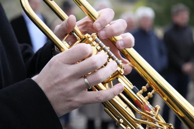 Musicians playing solemn music at a funeral ceremony.