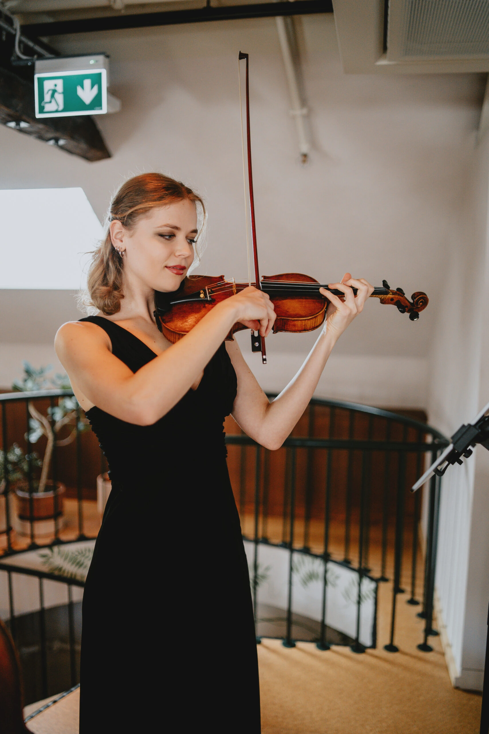 A girl playing the violin at a memorial service.