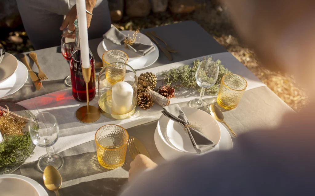 A beautifully set table ready for Christmas dinner with festive decorations.