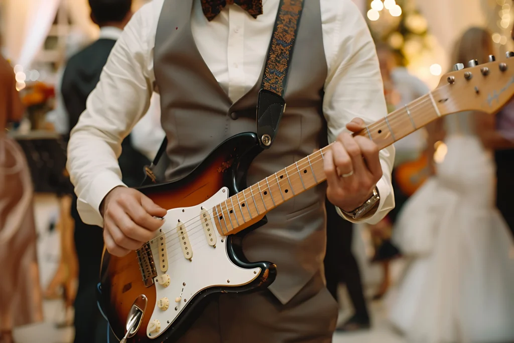 A man playing the electric guitar at a wedding ceremony.