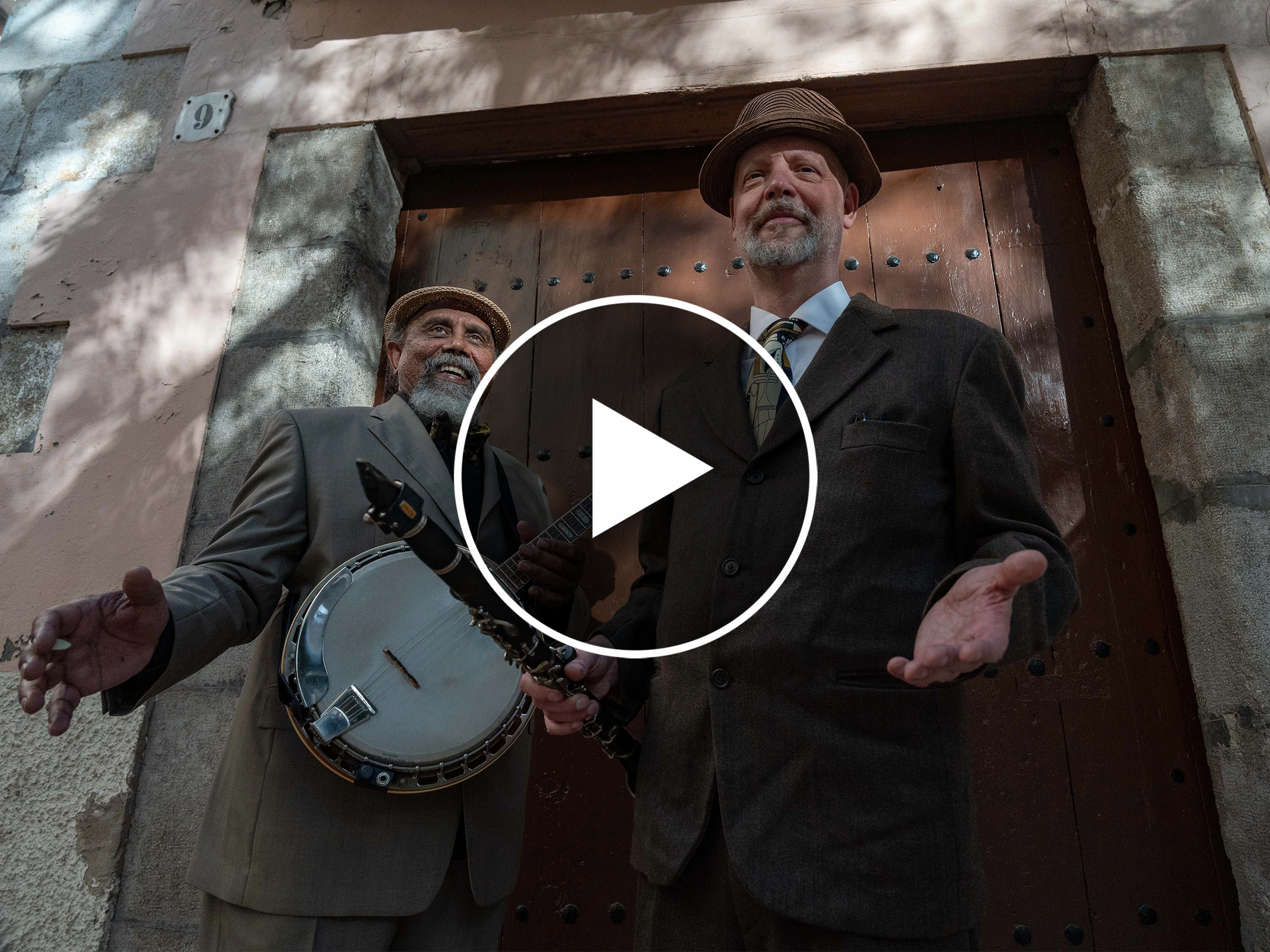 Two men performing glamorous 1920s rhythms, creating an elegant and retro atmosphere with vintage instruments